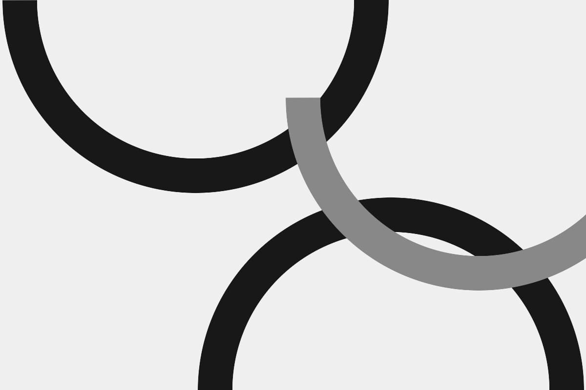 Abstract grayscale composition of three interlocking arcs.